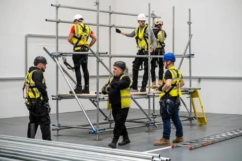 Scaffolding safety training session with workers indoors.