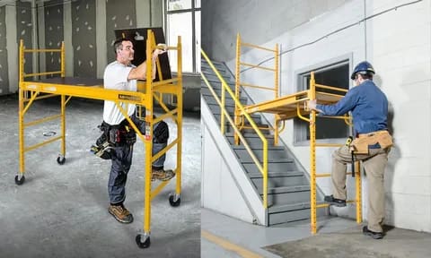 Workers using adjustable yellow scaffolding indoors and on stairs.