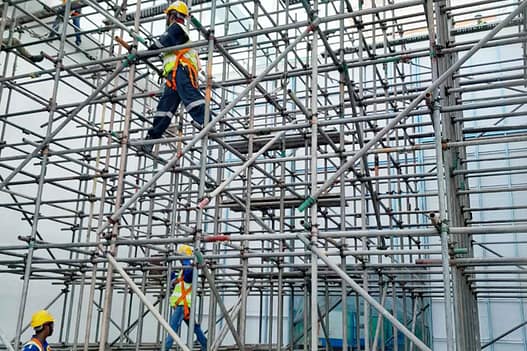 Workers on scaffolding with safety gear